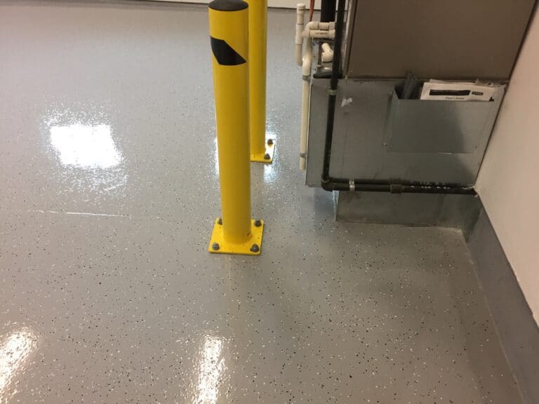 A floor with yellow poles and a door.