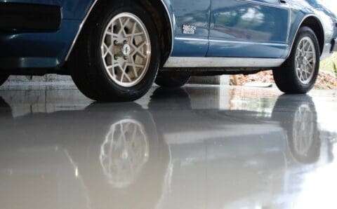 a blue car parked in a epoxy garage floor in monroe washington