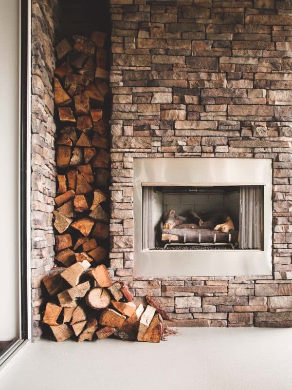 a beautiful fireplace on a waterproof deck with logs.
