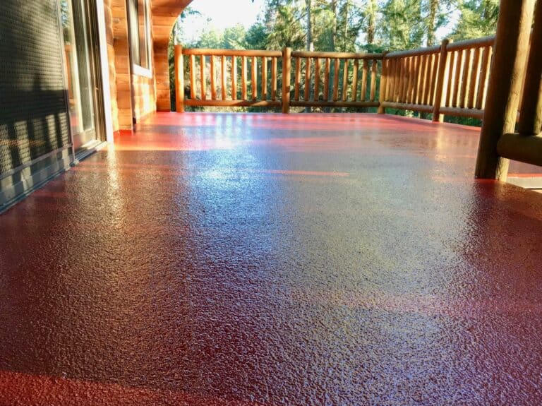 a red pattern urethane coating on a wood post deck.